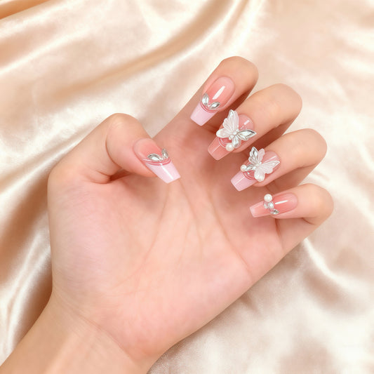 Blush Butterfly pink press-on nails with decorative butterfly accents