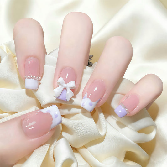 Lilac Bow press-on nails with lilac French tips and decorative bow accents